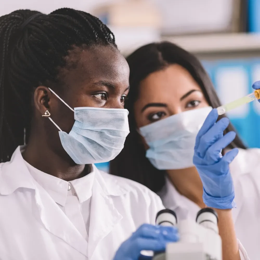 two women in laboratory analysing samples
