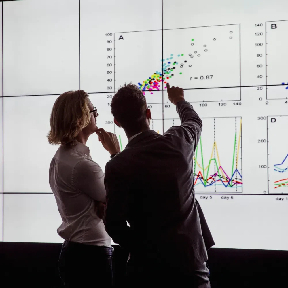 people analysing charts on a big screen