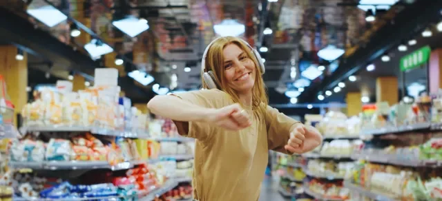woman with headphones in supermarket